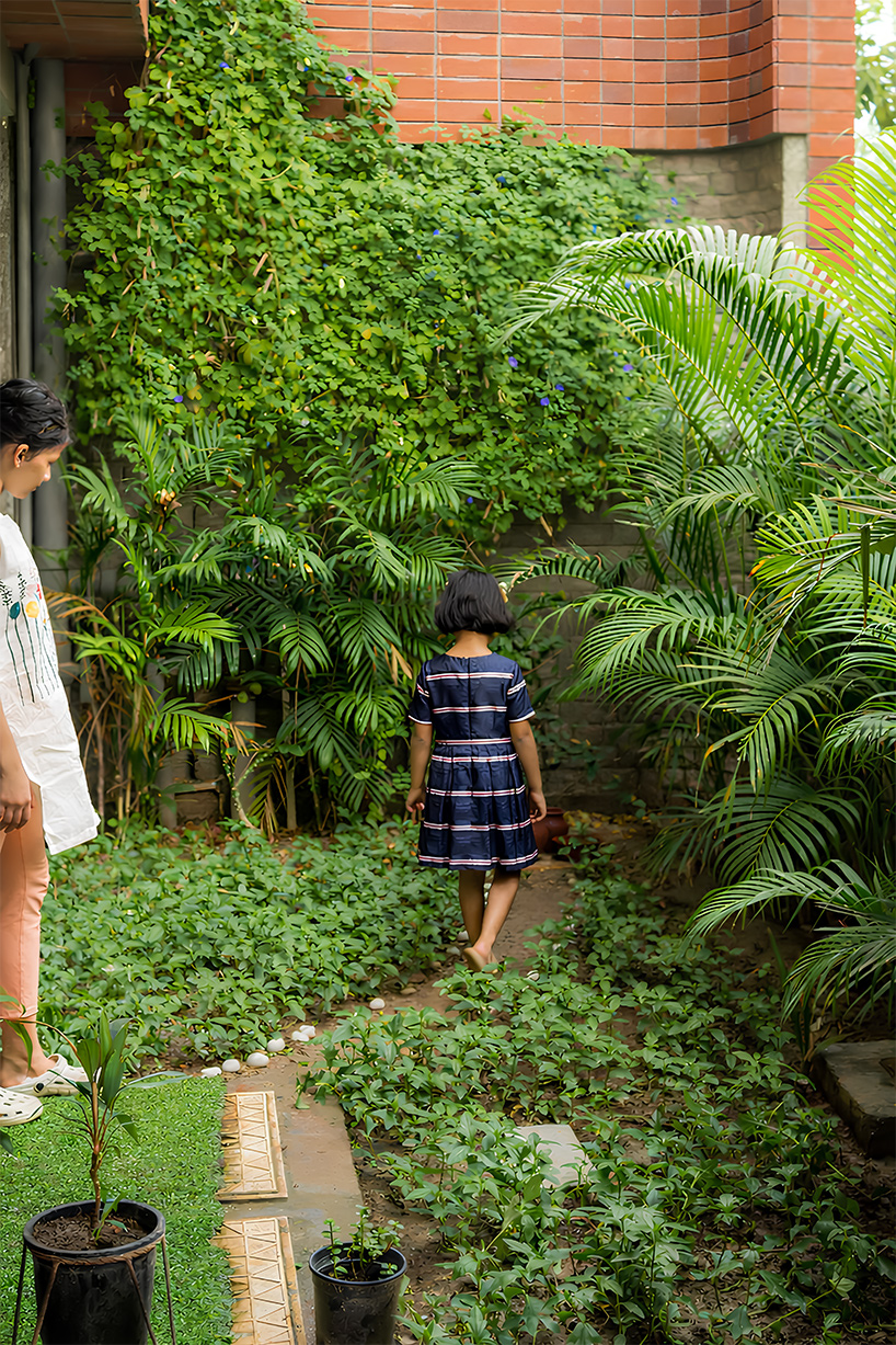 Curved balconies clad in brick tiles define a multi-generational home in Noida