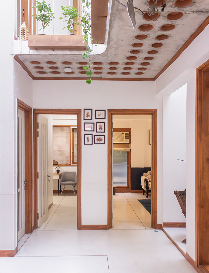 Curved balconies clad in brick tiles define a multi-generational home in Noida
