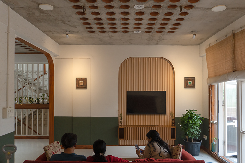 Curved balconies clad in brick tiles define a multi-generational home in Noida