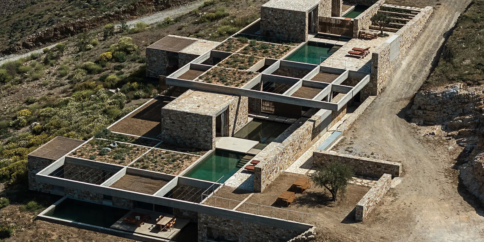 MOLD Architects утопили пять каменных резиденций в скалистом склоне острова Серифос
