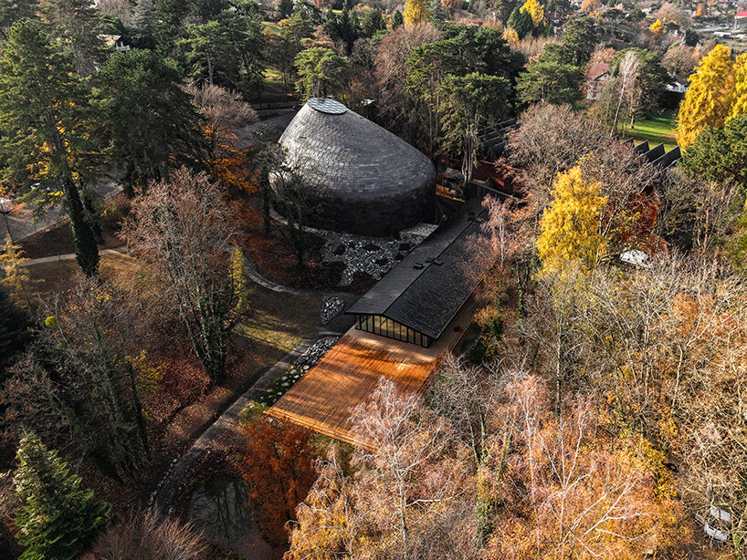 Copper shingles wrap curving concert hall ‘La Source Vive’ in Évian, France