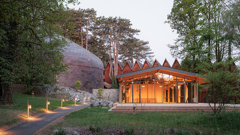 Copper shingles wrap curving concert hall ‘La Source Vive’ in Évian, France