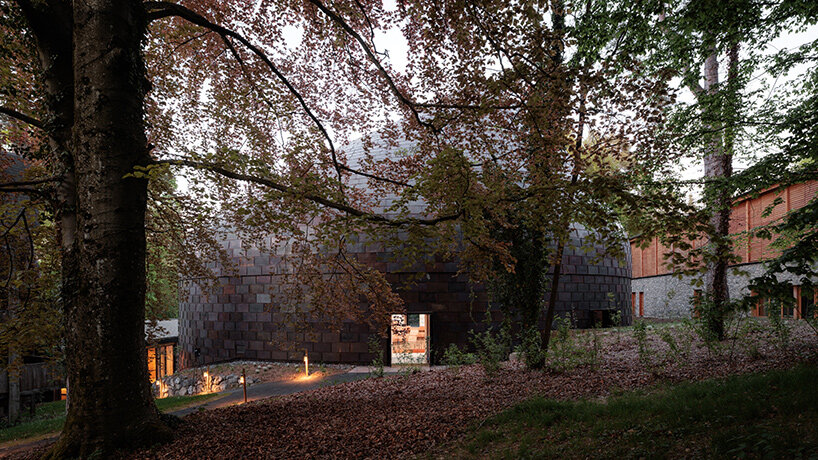 Copper shingles wrap curving concert hall ‘La Source Vive’ in Évian, France
