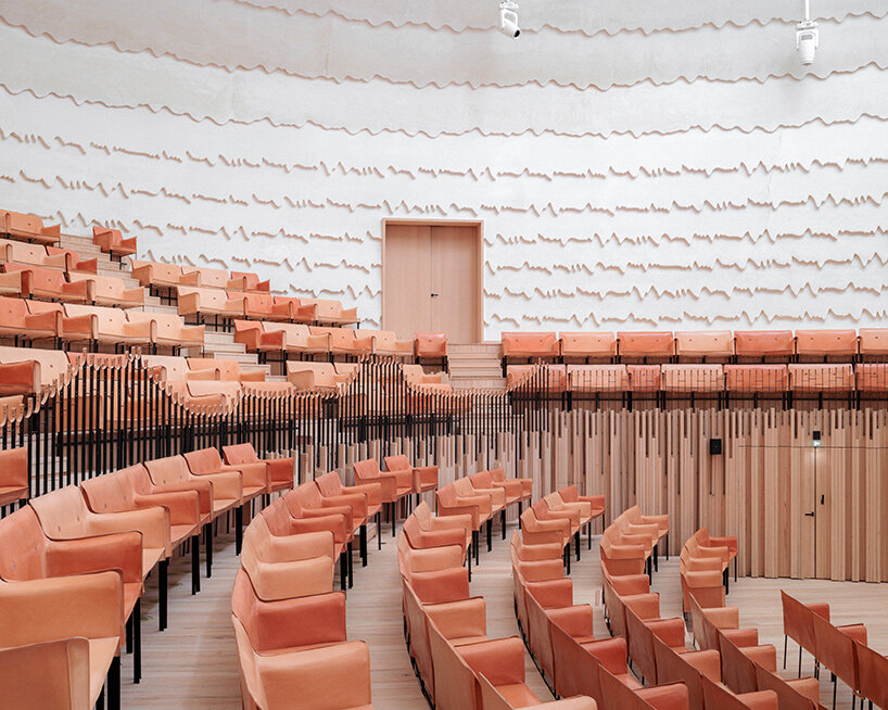 Copper shingles wrap curving concert hall ‘La Source Vive’ in Évian, France