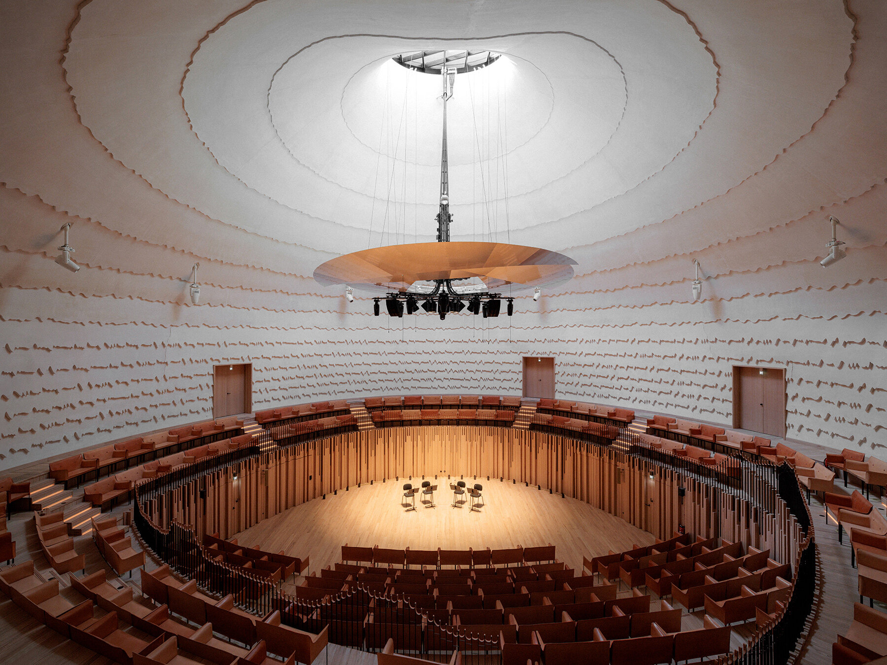 Copper shingles wrap curving concert hall ‘La Source Vive’ in Évian, France