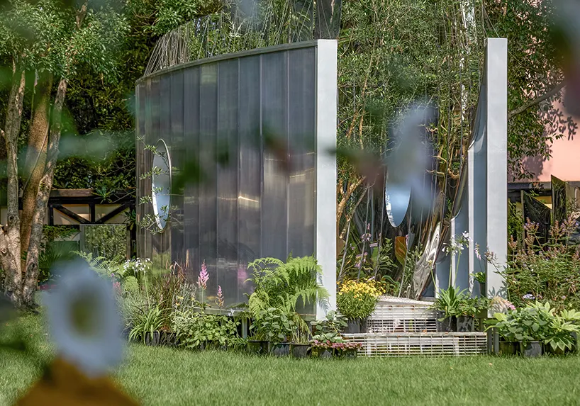 Curved mirrored steel walls multiply one tree into a forest in Infinite Grove pavilion in Shanghai