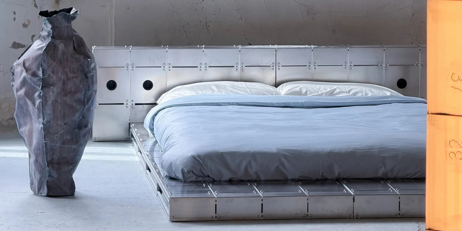 ALUMINUM AND BOLTED STEEL TURN PLATFORM BED INTO AN ARCHITECTURAL PIECE AT PARIS DESIGN WEEK